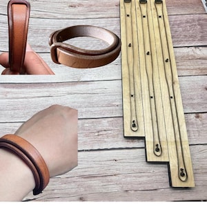 May include: A set of brown leather bracelets and a wooden die-cut template. The bracelets are made of thick, stitched leather. The die-cut template has several long, thin, curved shapes, likely for leather crafting. The bracelets appear to be approximately 2 inches wide.