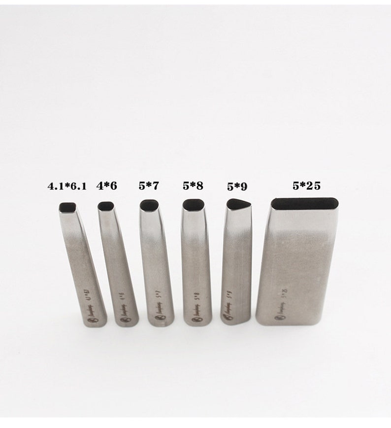 May include: A collection of six silver leathercraft tools, each with a different rectangular or oval cutting head. The tools are marked with sizes like 4*6 and 5*25. They are displayed vertically against a plain white backdrop.