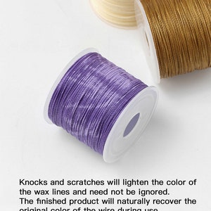May include: Spools of waxed cord in shades of purple, gold, and cream. The purple cord is in the foreground, with the text "Knocks and scratches will lighten the color of the wax lines and need not be ignored."