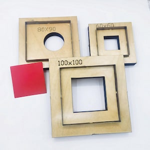 May include: A selection of wooden die cut templates in square and rectangular forms. The templates are labelled with dimensions: 60x60mm, 80x90mm, and 100x100mm. One template has a circular cutout. A small red square is also included.