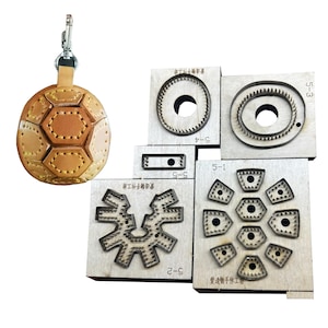 May include: A soccer ball-shaped leather keychain with a silver clasp hangs next to several wooden die-cut tools. The tools are various shapes, including circles, gears, and geometric shapes, for leather crafting.