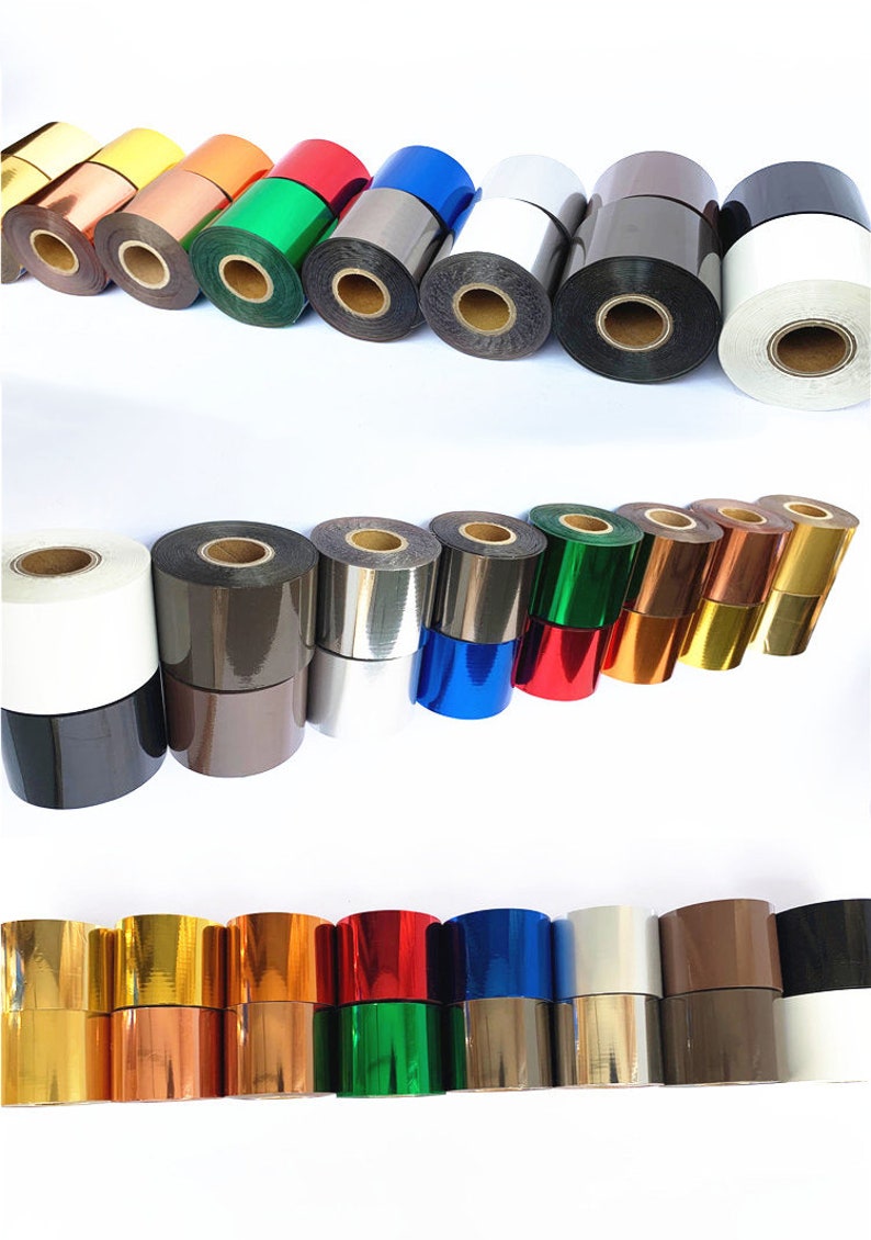 May include: A selection of metallic foil rolls in a range of colours, such as gold, silver, red, green, blue, and black. The rolls are stacked and arranged in rows, displaying the variety of colours and finishes.