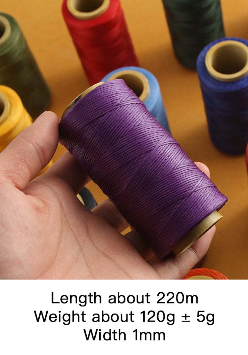 May include: A hand holds a spool of purple thread, with other spools of thread in various colors in the background. The text on the image reads: Length about 220m, Weight about 120g &plusmn; 5g, Width 1mm.
