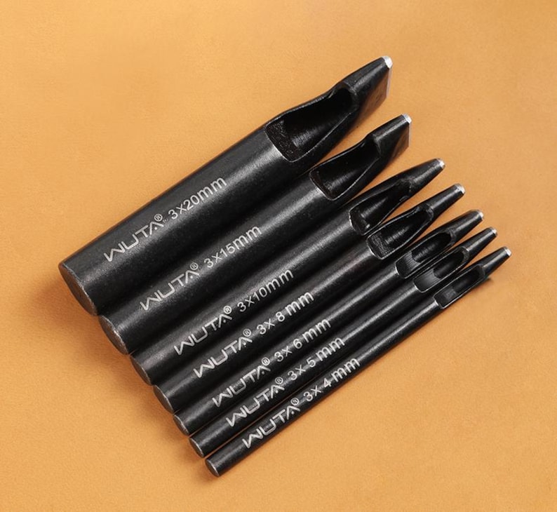 May include: A set of seven black leathercraft hole punches. Each punch is cylindrical with a flat, angled cutting edge. The sizes are labeled with white text: 3x20mm, 3x15mm, 3x10mm, 3x8mm, 3x6mm, 3x5mm, and 3x4mm.