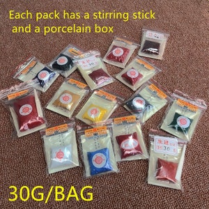 May include: A variety of small bags containing red, yellow, blue, green, and white powder. Each bag includes a small wooden stirring stick and a porcelain box. The bags are labeled with Chinese characters and the text "30G/BAG".