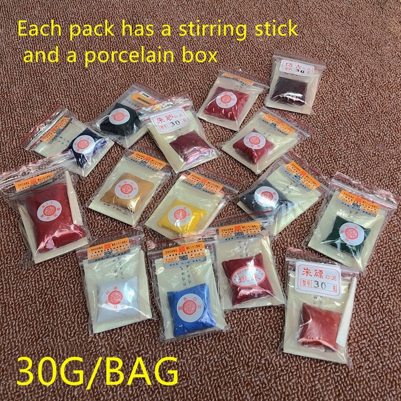 May include: A variety of small bags containing red, yellow, blue, green, and white powder. Each bag includes a small wooden stirring stick and a porcelain box. The bags are labeled with Chinese characters and the text "30G/BAG".