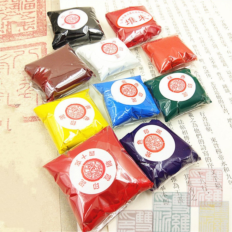 May include: Assortment of ten small bags of red, yellow, blue, green, white, black, purple, and orange ink powder. Each bag has a red circular label with Chinese characters.