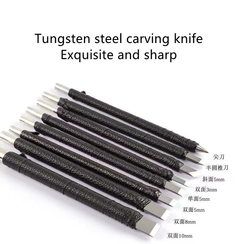 May include: Set of ten tungsten steel carving knives with black leather handles. The blades are various shapes and sizes, including single-sided and double-sided blades. The blades are labeled with their size in millimeters: 3mm, 5mm, 8mm, and 10mm.