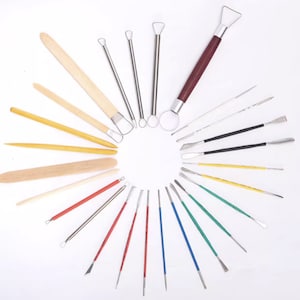 May include: A set of 20 pottery tools, including wooden and metal sculpting tools. The tools are arranged in a circle on a white background.