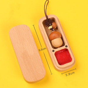 May include: A wooden box with a red interior and a small wooden acorn charm. The box is 9.8 inches long and 3.8 inches wide.