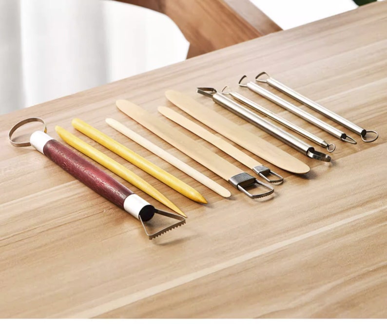 May include: A set of 10 pottery tools for sculpting and shaping clay. The tools include a variety of shapes and sizes, including a loop tool, a scraper, a rib tool, and a needle tool. The tools are made of wood and metal and are designed to be durable and easy to use.