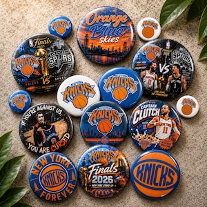 May include: A collection of circular pin-back buttons featuring New York Knicks basketball team branding, player imagery, and championship-themed graphics in blue and orange. The designs include text such as Orange and Blue skies, Finals 2025, and Captain Clutch.