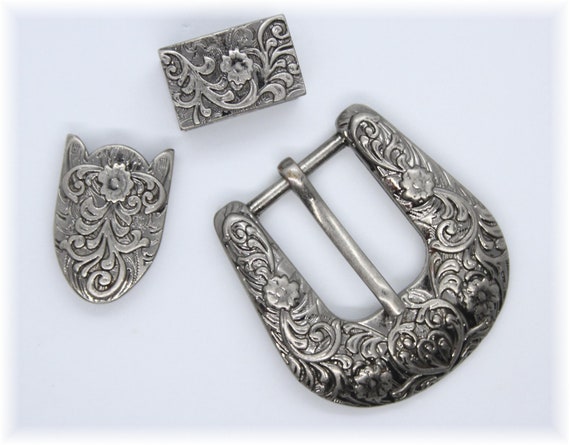 Lot - Four antique sterling silver monogram belt buckles.