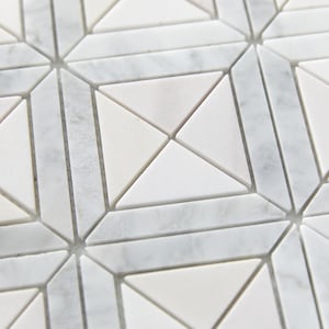 May include: White marble mosaic tile with a geometric pattern of triangles and squares. The tile has a subtle grey veining.