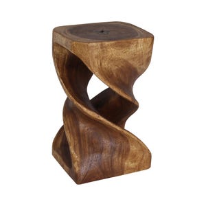 May include: A brown wooden stool featuring a solid square top and a base carved into a continuous, spiraling, twisted shape. The wood grain is visible throughout the surface, showcasing natural patterns and a dark, polished finish.