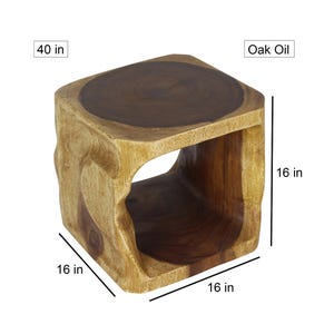 May include: A wooden stool with a square top and a square opening in the side. The stool is 16 inches wide, 16 inches deep, and 16 inches tall. The stool is made of solid wood and has a natural finish. The stool is finished with oak oil.