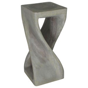 May include: A gray wooden stool with a twisted design. The stool has a square top and a unique, organic shape.