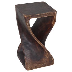 May include: A dark brown wooden stool with a unique twisted design. The stool is made of solid wood and has a smooth, polished finish.