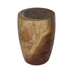 May include: A cylindrical stool crafted from a single piece of natural wood, featuring a smooth, flat top surface with visible circular grain patterns and a warm, variegated brown finish that highlights the organic texture of the wood grain.