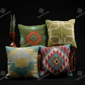 May include: Four decorative throw pillows with geometric patterns in shades of green, blue, yellow, red, and brown. The pillows are arranged on a wicker chair.