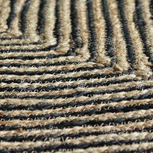 May include: Close-up of a black and natural jute rug with a geometric pattern. The rug is made of woven strands of jute and black yarn.