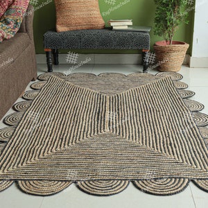 May include: A black and natural jute rug with a geometric pattern and scalloped edges. The rug is made of natural fibers and has a rustic look.