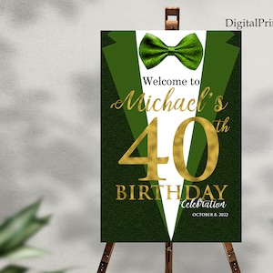 May include: Green and white welcome sign with a gold bow tie and the text "Welcome to Michael's 40th Birthday Celebration October 8, 2022".