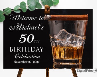 May include: A black and white welcome sign for a 50th birthday celebration. The sign features a glass of whisky with ice and a cigar. The text reads "Welcome to Michael's 50th Birthday Celebration November 27, 2021".