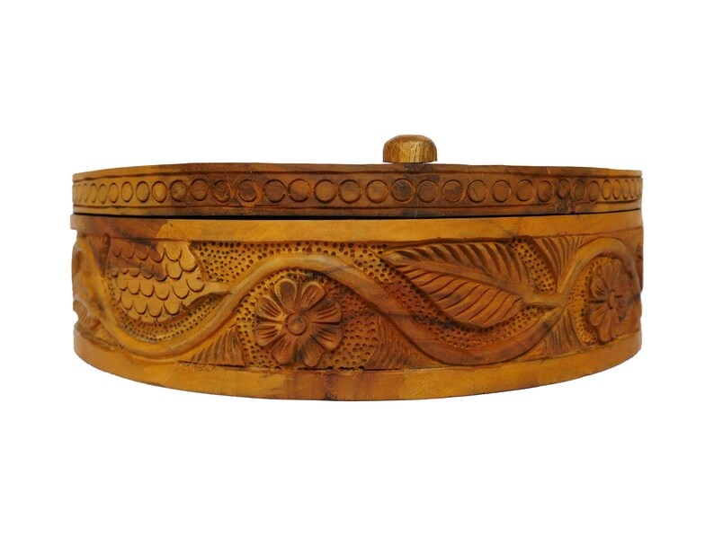 May include: A wooden box with a carved floral design. The box is brown and has a lid.