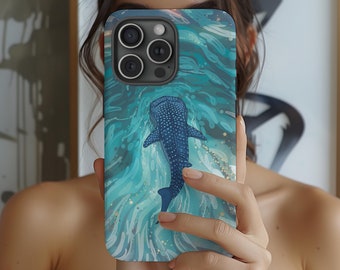 May include: A phone case with a blue whale shark swimming in a turquoise and blue ocean with gold glitter accents.