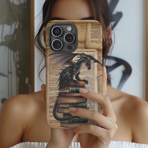 May include: A black dragon perched on a stack of vintage books. The phone case features a vintage book design with a black dragon illustration.