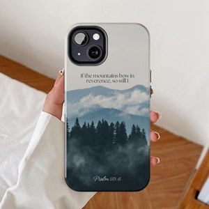 May include: A white phone case featuring a misty mountain scene with the text "If the mountains bow in reverence, so will I. Psalm 95:6"