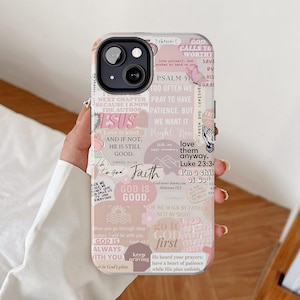 May include: A pink phone case decorated with a variety of colourful stickers featuring inspirational quotes and bible verses. The stickers include phrases such as "God is good", "Love is kind", "Faith", and "God calls you worthy".