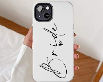 May include: White phone case with a black cursive inscription that says "Bride" with a small heart.