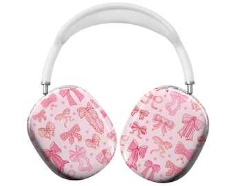 May include: White wireless headphones with a pink and red bow pattern on the earcups.