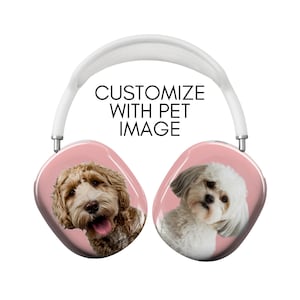 May include: A pair of pink wireless headphones with a white headband. The earcups feature images of two dogs, one a brown and white doodle and the other a white and gray shih tzu. The text "CUSTOMIZE WITH PET IMAGE" is printed on the headband.
