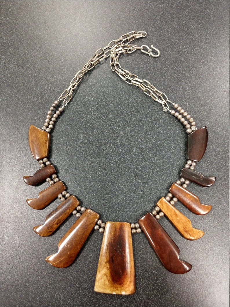 African; bone; horn; brown; pewter; chain; bib;