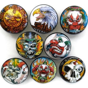 May include: Nine round, colorful buttons with various designs. The designs include a skull with a top hat, a clown face, a sun, an eagle, and a skull with an eye.