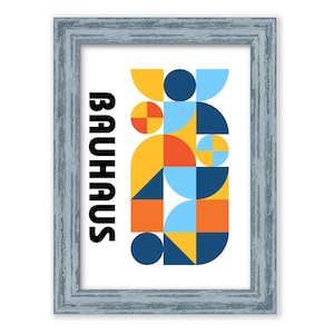 May include: A framed print with a geometric design in shades of yellow, blue, red, and orange. The word "Bauhaus" is printed in black on the left side of the print.