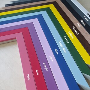 May include: A collection of colorful picture frames in various shades, including pink, red, purple, blue, and green. Each frame is labeled with its color name in white text. The frames are arranged in a diagonal pattern, showcasing their different hues.