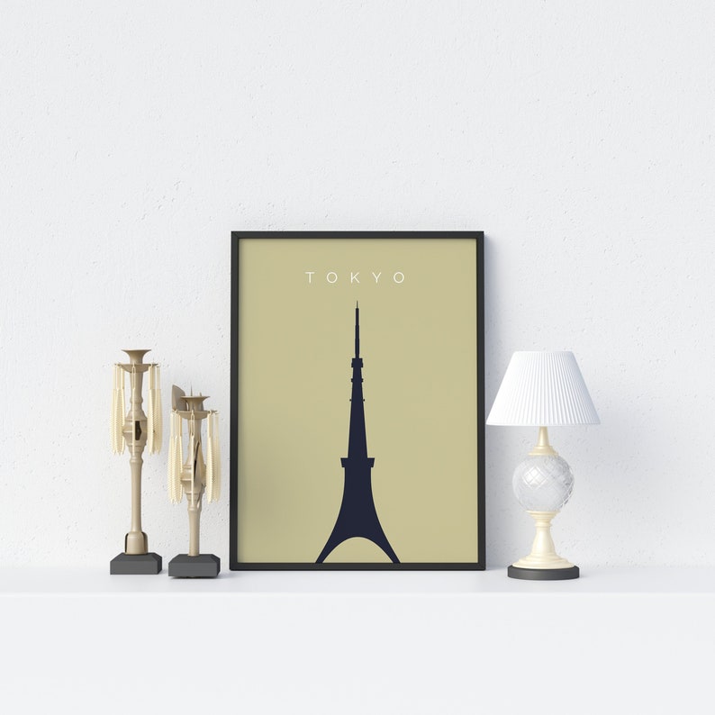 May include: A black framed print with the word "TOKYO" in white text at the top and a silhouette of a tower in the center on a beige background.