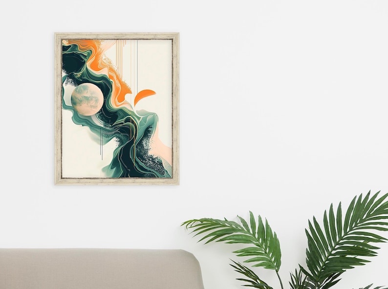 May include: Abstract art print in a white frame with a green, orange, and white color scheme. The print features a large, round, white shape with a textured surface, surrounded by swirling, abstract shapes in shades of green and orange.