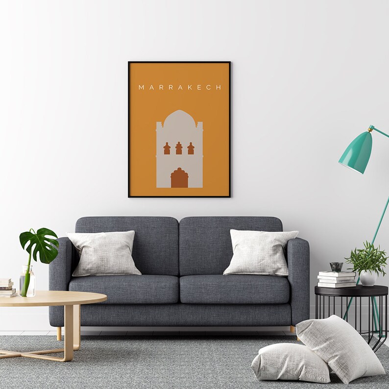 May include: A framed print with a minimalist design of a building in a muted orange and gray color scheme. The text "MARRAKECH" is at the top of the print.