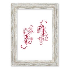 May include: A framed print with two red line drawings of tigers on a white background. The tigers are facing each other and appear to be in a playful pose.