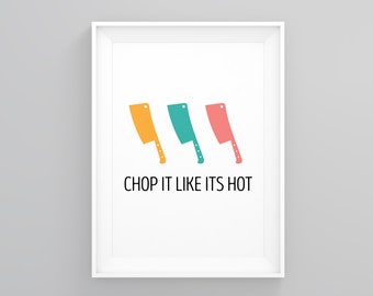 May include: A white framed print with three colorful cartoon chef's knives and the text "CHOP IT LIKE ITS HOT".