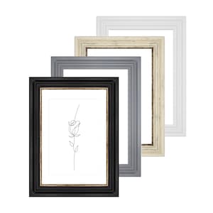 May include: Three picture frames in different colors and styles. The frames are nested inside each other, with the black frame in the front, the gray frame in the middle, and the white frame in the back. The frames are all rectangular and have a simple design.