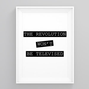May include: Black and white typography print with the text "THE REVOLUTION WON'T BE TELEVISED" in a white frame.