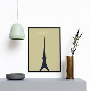 May include: A black framed print with a beige background and a dark blue silhouette of the Tokyo Skytree. The text "TOKYO" is printed in white at the top of the print.