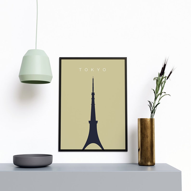 May include: A black framed print with a beige background and a dark blue silhouette of the Tokyo Skytree. The text "TOKYO" is printed in white at the top of the print.