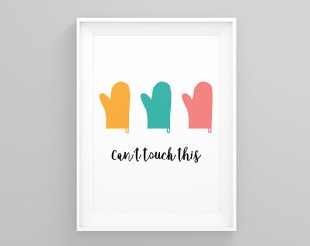 May include: A white framed print with three colorful oven mitts in yellow, teal, and pink. The text "Can't touch this" is written below the mitts.
